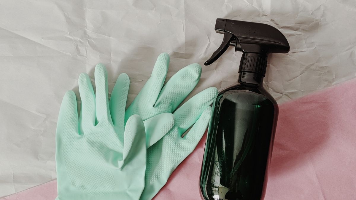 cleaning tools with spray bottle and rubber gloves