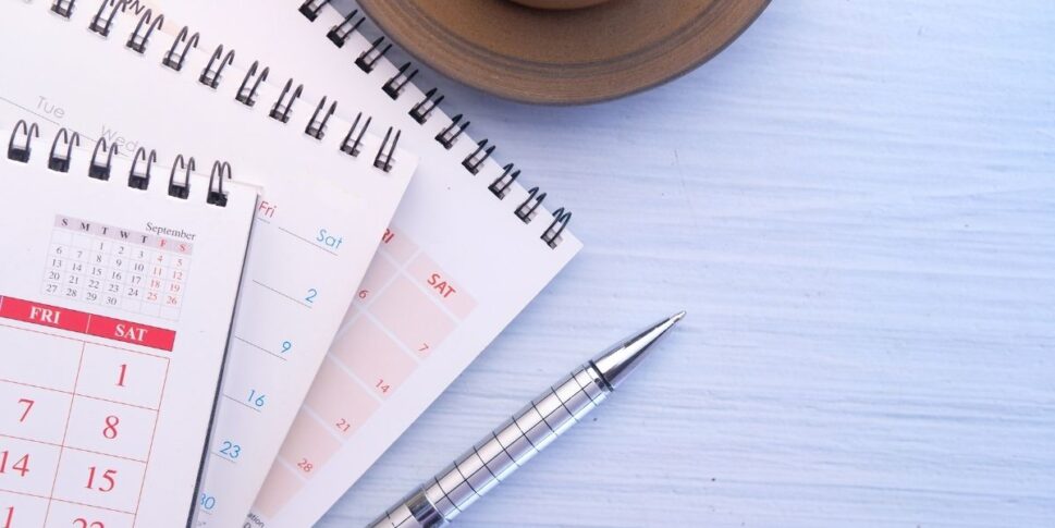 calendar and planner and pen on table