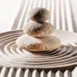 rocks balanced on each other with zen sand formation